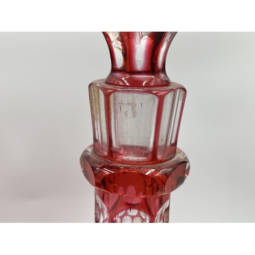 267 - A pair of cranberry glass decanters - approx. 30cm high