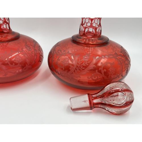 267 - A pair of cranberry glass decanters - approx. 30cm high