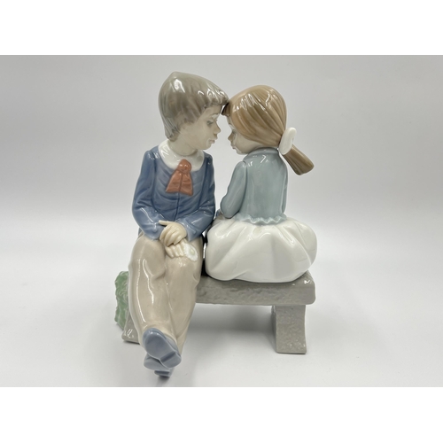 275 - Two ceramic figurines, one Royal Doulton Melanie HN 2271 and one Nao by Lladro First Love - model no... 