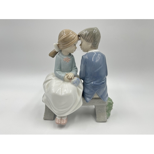 275 - Two ceramic figurines, one Royal Doulton Melanie HN 2271 and one Nao by Lladro First Love - model no... 