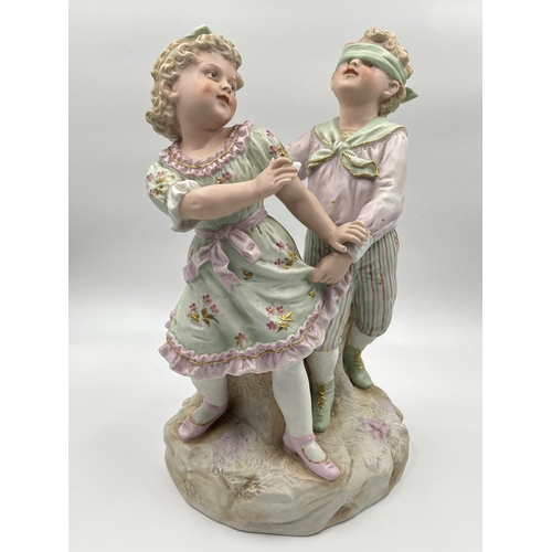 284G - An antique German bisque porcelain figurine of boy and girl - approx. 32cm high