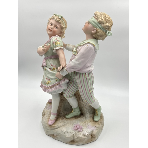 284G - An antique German bisque porcelain figurine of boy and girl - approx. 32cm high