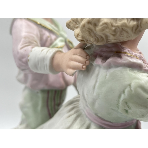 284G - An antique German bisque porcelain figurine of boy and girl - approx. 32cm high