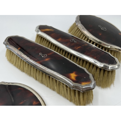 1239 - An Adie Brothers Ltd hallmarked Birmingham silver and tortoise shell five piece dressing table set, ... 