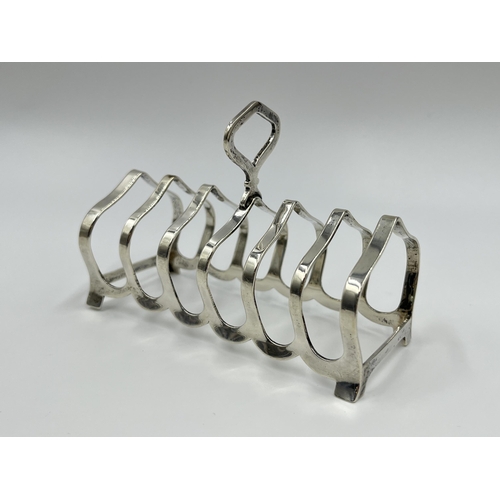 1241 - Two hallmarked sterling silver toast racks, one William Suckling Ltd Birmingham silver dated 1932 an... 