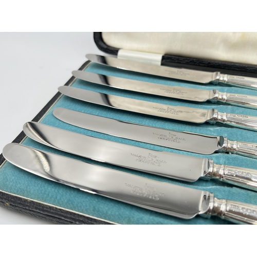 1242 - A cased set of six Walker & Hall hallmarked Sheffield silver handled knives, dated 1932