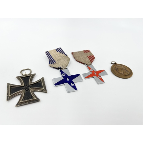 1263 - Four medals to include GIL crosses, German Iron Cross etc.