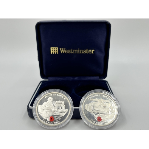 1289 - A cased set of two 2004 Queen Elizabeth II .925 silver five pound coins, one Pegasus Bridge and one ... 