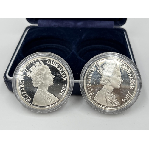 1289 - A cased set of two 2004 Queen Elizabeth II .925 silver five pound coins, one Pegasus Bridge and one ... 