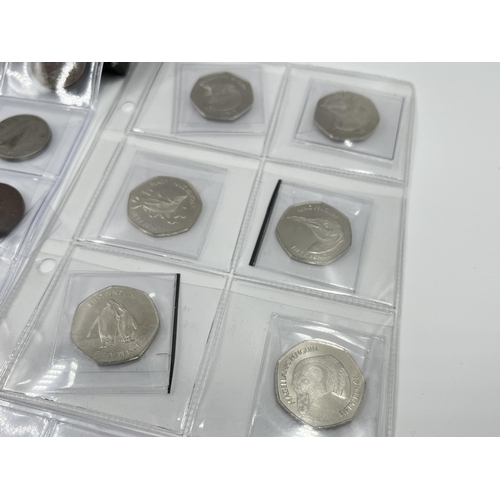 1300 - A collection of world wide coins to include six Elizabeth II Falkland Island penguin 50 pences, case... 