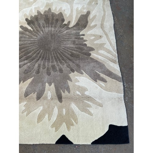 173 - A Next Black Poppy 100% acrylic rug - approx. 230cm x 170cm