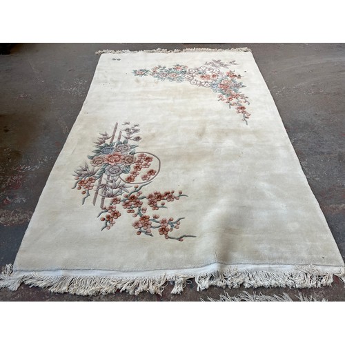 175 - Two Chinese rugs, one 100% wool pile - approx. 290cm x 185cm and one oval blue floral pattern - appr... 