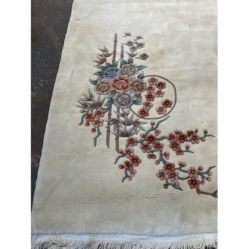 175 - Two Chinese rugs, one 100% wool pile - approx. 290cm x 185cm and one oval blue floral pattern - appr... 