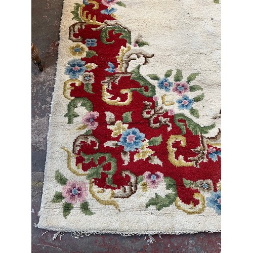 176 - An Oriental floral patterned rug - approx. 350cm x 275cm