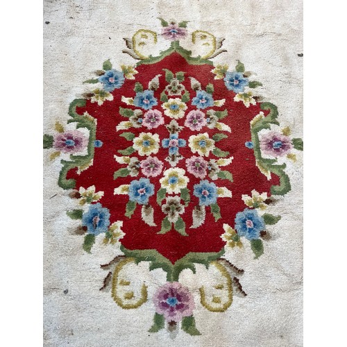 176 - An Oriental floral patterned rug - approx. 350cm x 275cm