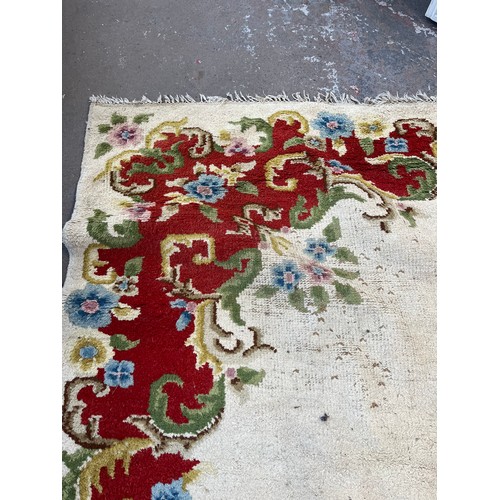 176 - An Oriental floral patterned rug - approx. 350cm x 275cm