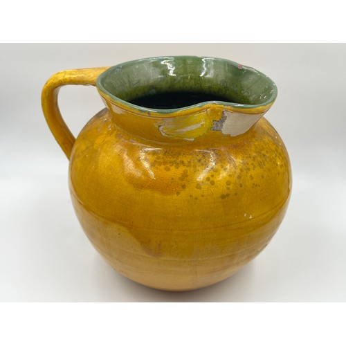 284D - An early 20th century C. H. Brannan yellow glazed jug - approx. 22cm high