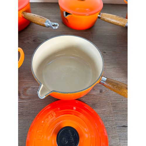 Eight items of good quality cookware to include four Le Creuset wooden