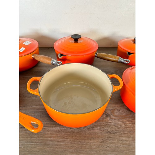 Eight items of good quality cookware to include four Le Creuset wooden