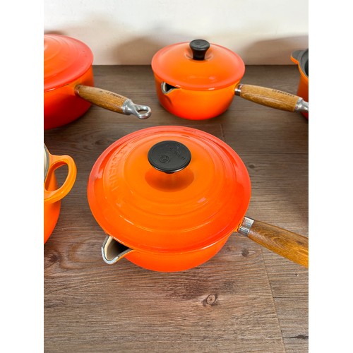 Eight items of good quality cookware to include four Le Creuset wooden