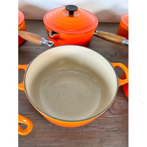 Eight items of good quality cookware to include four Le Creuset wooden