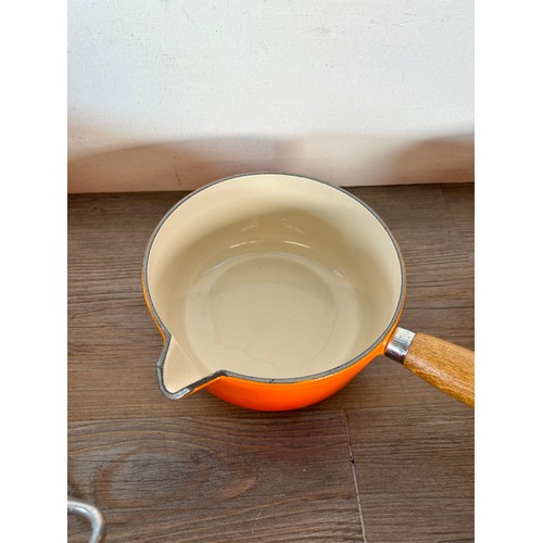 Eight items of good quality cookware to include four Le Creuset wooden