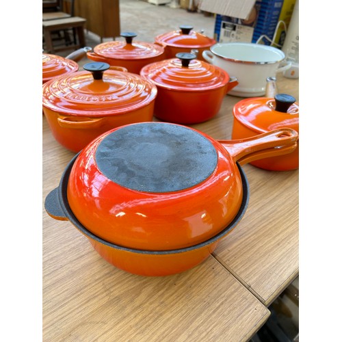 Eight items of good quality cookware to include four Le Creuset wooden