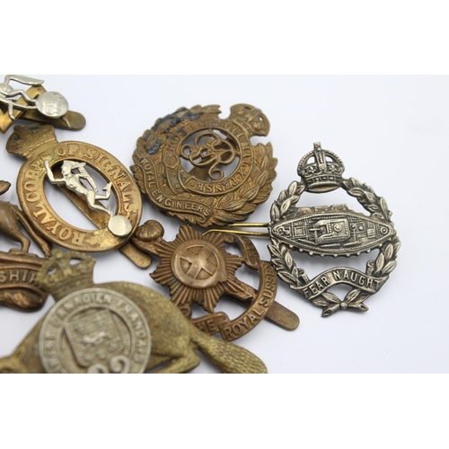 1158 - Ten military cap badges to include Tank Regiment, Nato, Canadian etc.