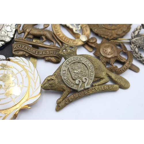 1158 - Ten military cap badges to include Tank Regiment, Nato, Canadian etc.