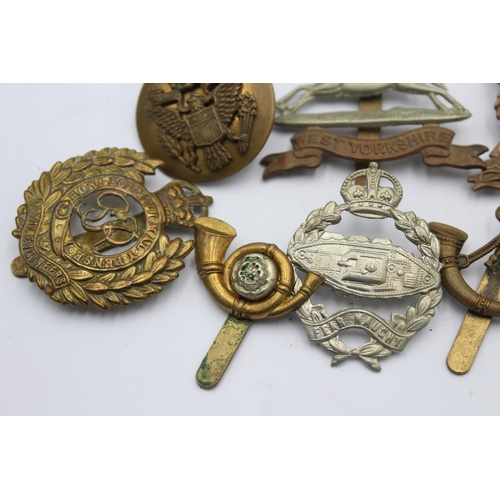 1159 - Ten military cap badges to include West Yorkshire, A.T.S, East Surrey etc.