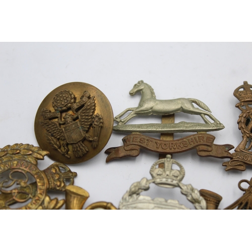 1159 - Ten military cap badges to include West Yorkshire, A.T.S, East Surrey etc.