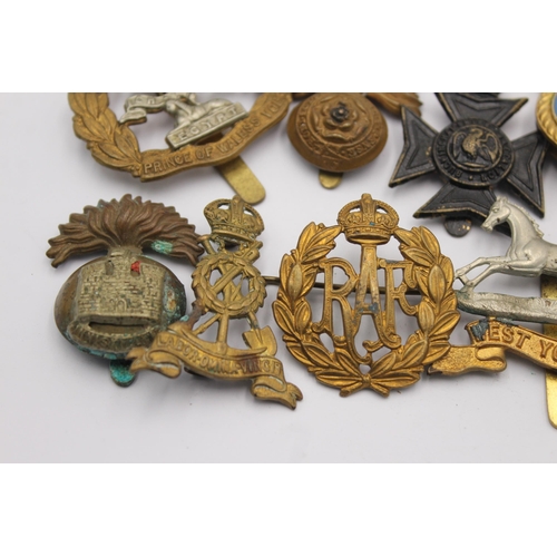 1160 - A collection of military cap badges to include RAF, R.N.X.S etc.