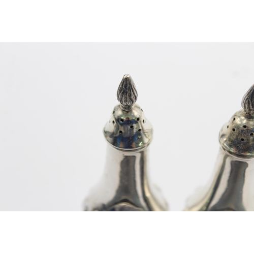 1194 - A pair of hallmarked Sheffield sterling silver salt and pepper shakers, dated 1987 - approx. gross w... 