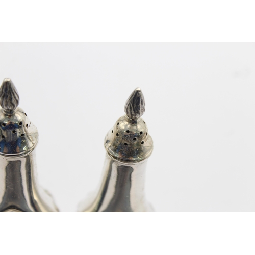 1194 - A pair of hallmarked Sheffield sterling silver salt and pepper shakers, dated 1987 - approx. gross w... 