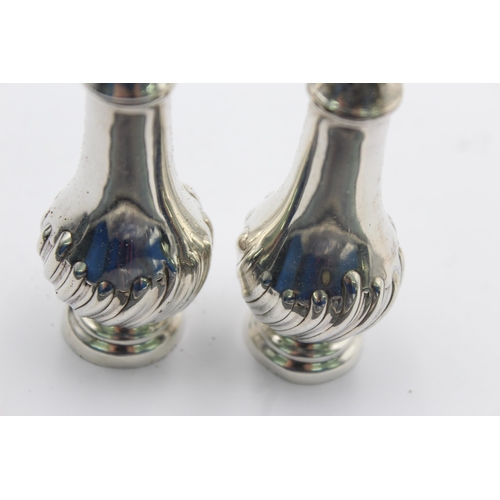 1194 - A pair of hallmarked Sheffield sterling silver salt and pepper shakers, dated 1987 - approx. gross w... 