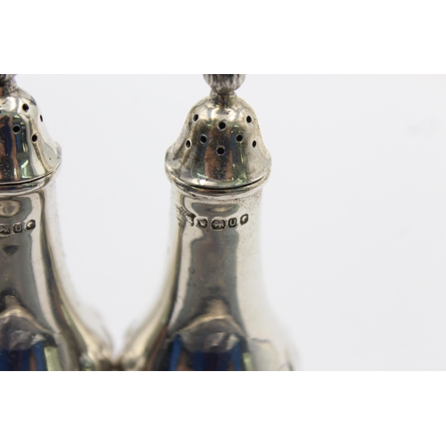 1194 - A pair of hallmarked Sheffield sterling silver salt and pepper shakers, dated 1987 - approx. gross w... 