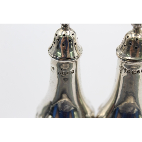 1194 - A pair of hallmarked Sheffield sterling silver salt and pepper shakers, dated 1987 - approx. gross w... 