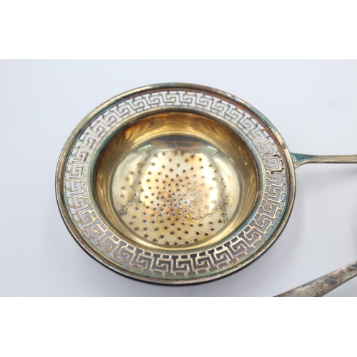 1199 - Three pieces of hallmarked sterling silver, two tea strainers and one sugar sifter - approx. gross w... 