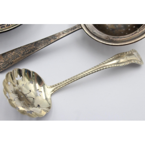 1199 - Three pieces of hallmarked sterling silver, two tea strainers and one sugar sifter - approx. gross w... 