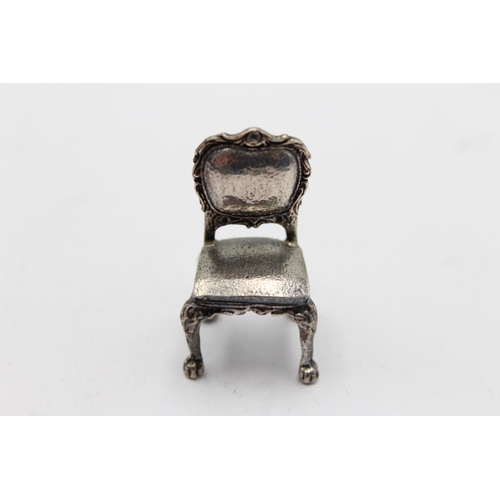 1213 - Two vintage hallmarked silver miniature doll's house chairs, one .800 and one .950 - approx. gross w... 