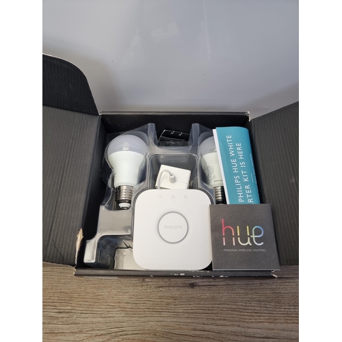 560 - Two items, one sealed Google Home Mini smart speaker and one Phillips Hue white light-automation sta... 