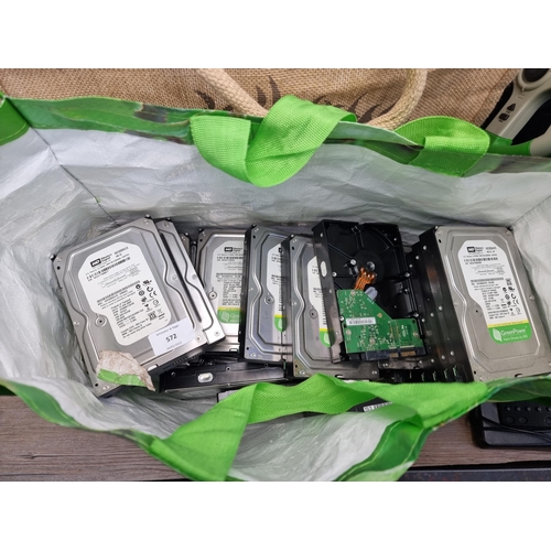 572 - Two bags containing various hard drives and gaming equipment