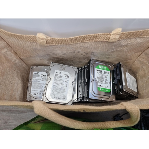 572 - Two bags containing various hard drives and gaming equipment