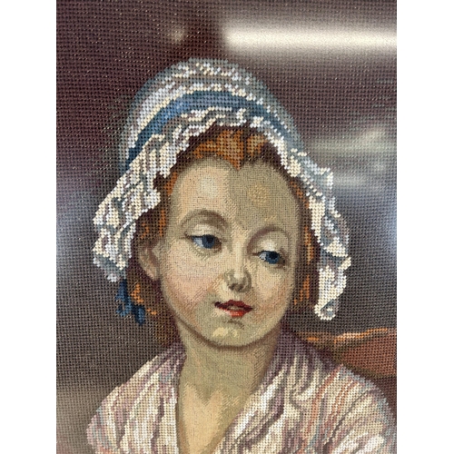 176 - A framed tapestry of a lady sewing - approx. 80cm high x 60cm wide