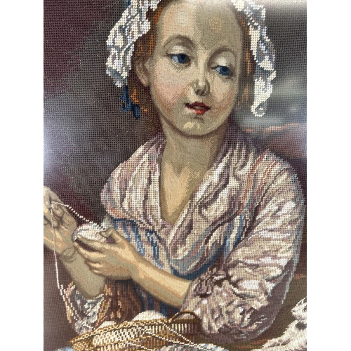 176 - A framed tapestry of a lady sewing - approx. 80cm high x 60cm wide