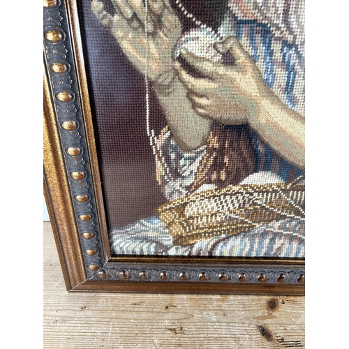 176 - A framed tapestry of a lady sewing - approx. 80cm high x 60cm wide