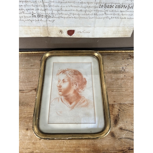 190 - Two gilt framed items, one mid 18th century indenture and one early 20th century portrait of a femal... 