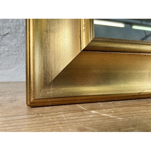 196 - A modern gilt framed wall mirror - approx. 118cm high x 92cm wide