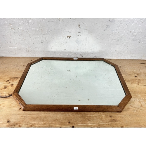 197 - An early 20th century oak framed octagonal wall mirror - approx. 56cm high x 80cm wide