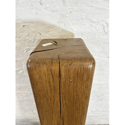 64 - An oak free standing corner cabinet with two upper leaded glass doors and two lower cupboard doors